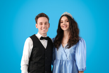 Beautiful couple dressed for prom on blue background