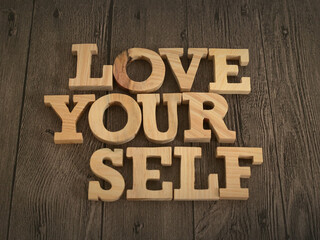 Love yourself, text words typography written with wooden letter, life and business motivational inspirational - obrazy, fototapety, plakaty
