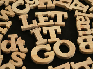Let it go, text words typography written with wooden letter, life and business motivational...