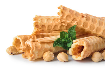 Delicious wafer rolls, hazelnuts and mint isolated on white background