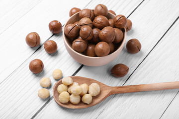 Delicious organic Macadamia nuts on white wooden table