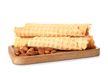Board with delicious wafer rolls and almond nuts isolated on white background