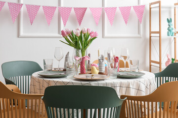 Interior of dining room with table served for Easter celebration