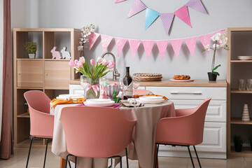 Interior of kitchen with festive table served for Easter celebration