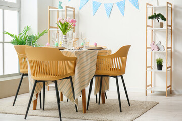 Interior of dining room with table served for Easter celebration