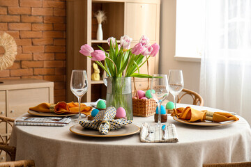 Interior of dining room with table served for Easter celebration