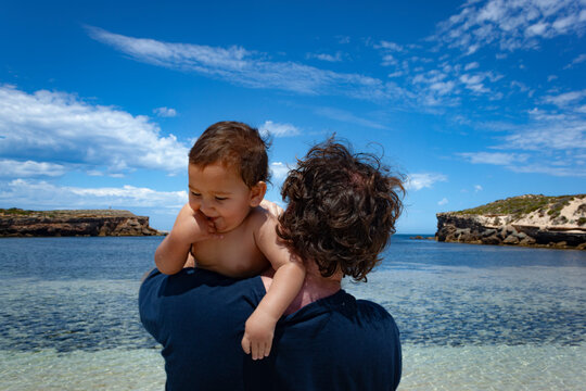 Father and son with the cliffs of Pondalowie Bay in the background ath Innes National Park, Australia.