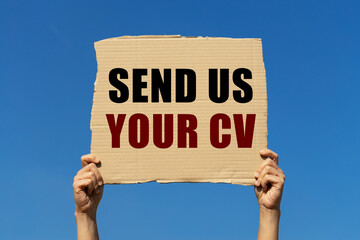 Send us your CV text on box paper held by 2 hands with isolated blue sky background. This message...