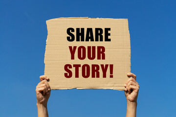 Share your story text on box paper held by 2 hands with isolated blue sky background. This message...