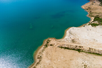 Aerial view of the coastline of a flooded sand pit
