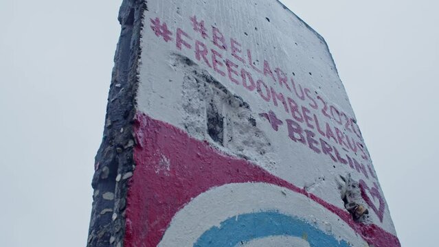 Closeup of Berlin wall with graffiti about Belarus freedom, circle pan, day