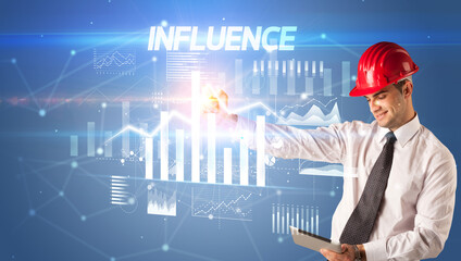 Young businessman with helmet drawing on virutal screen