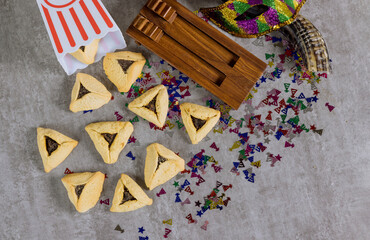 Purim celebrations with hamantaschen cookies shofar noisemakers, tallit carnival masks are symbols...