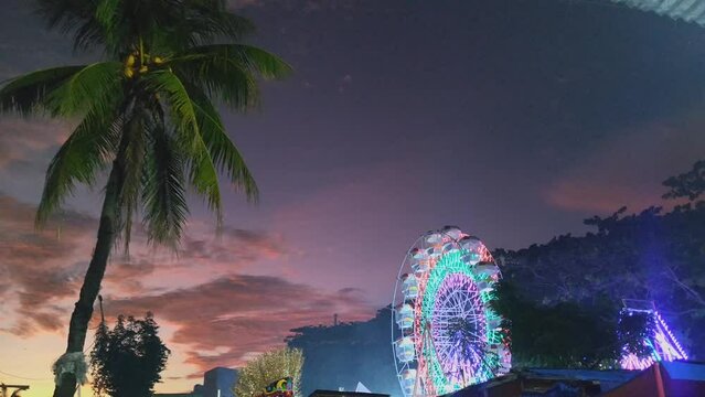 BKT Ferris wheel sunset sky coconut tree