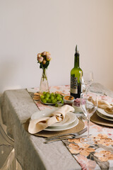 Vintage table setting with Linen napkins and floral decorations. Close up. Cozy calm meal in the morning in the sunshine.