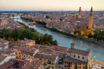 Fototapeta na wymiar Aerial Skyline View of Verona, Italy at Sunset. Verona offers travelers the opportunity to visit grand buildings with unique architecture, squares lined with outdoor restaurants and Roman ruins. 