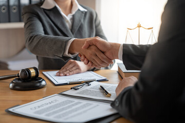 Lawyers shake hands with business people to seal a deal with partner lawyers. or a lawyer...