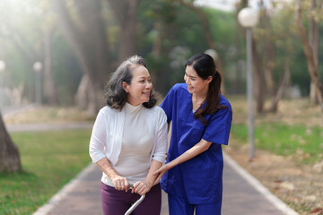 Healthcare nurse, physical therapy with elderly woman at outdoor. Nurse holding hand and help elderly woman walking