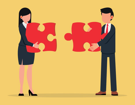 Business Metaphor Of A Joint Venture. Business Man And Women Joining Together Large Jigsaw Puzzle Pieces.