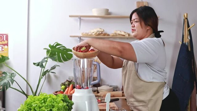 Asian obese woman taking care health by drinking fruit and vegetable juices blended into blender for healthy body. Lose weight and detoxify the intestines reducing the risk of cardiovascular disease.