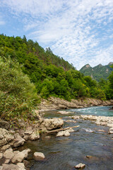 Obraz premium Summer, river, mountainous terrain, tourist routes running through the park, a place for walking and recreation.