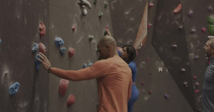 Instructor Teaching Sports People Climbing on Indoor Climbing wall