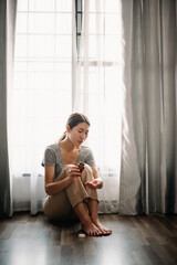 woman sit Depression Dark haired  pensive glance Standing by window and anxiety Copy space. .