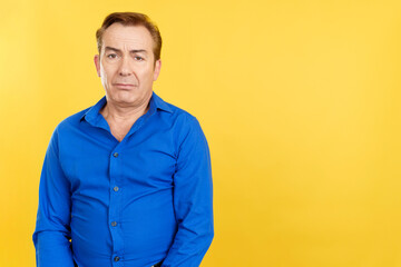 Mature man looking at camera with sad expression