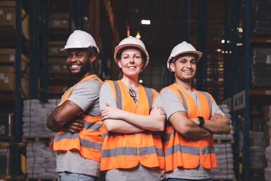 Group worker in safety hat arms crossed smiling teamwork proud of success at warehouse, Logistic inventory teamwork concept