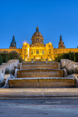 Naklejka premium The National Palace on Montjuic mountain in Barcelona illuminated at twilight