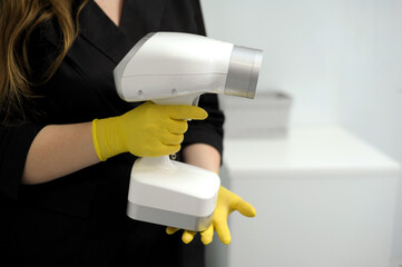 portable x-ray beautiful young female doctor in her hands with portable x-ray prepared to take a...