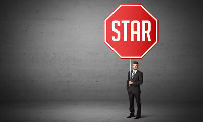 Young business person holding road sign