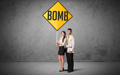 Young business person holding road sign