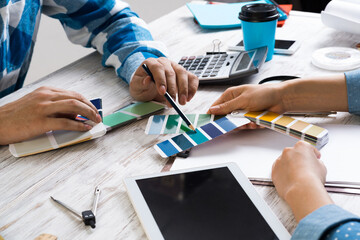 Designers discussing color palette at desk