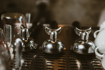 Fototapeta na wymiar barista pick coffee bottomless portafilter to make a coffee at cafe. Coffee maker concept.