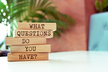 Wooden blocks with words 'What questions do you have?'.