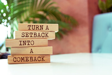 Wooden blocks with words 'Turn a setback into a comeback'.