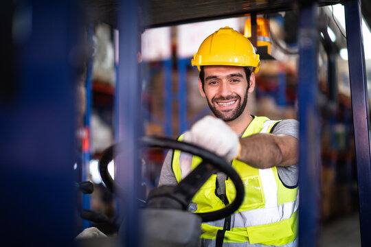 Caucasian male warehouse worker working control loading operate folk lift in warehouse inventory factory.