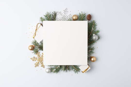 Christmas decorations with mock up greetings card and gifts on white background. Flat lay, copy space
