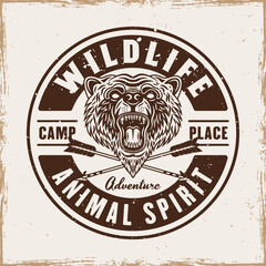Obraz premium Bear vintage grunge style round emblem, badge, label or logo with headline wildlife vector illustration