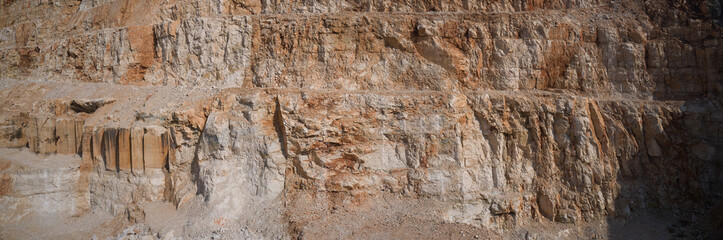 Panorama of an open pit. Marble quarry in Italy. Red marble in a quarry.
