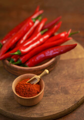 Red hot chili peppers on old wooden table