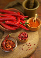 spicy food. Top view red dried crushed hot chili and raw chili in wooden bowl on rustic background, healthy spice