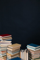 large number of books stacked on a black background in the library science knowledge