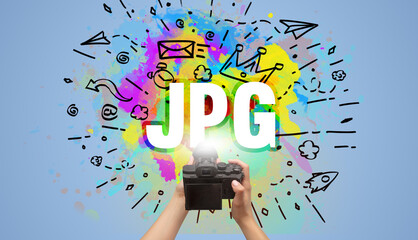 Close-up of a hand holding digital camera with abstract drawing