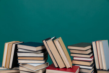 many books stacked on a table on a green background in the science knowledge library