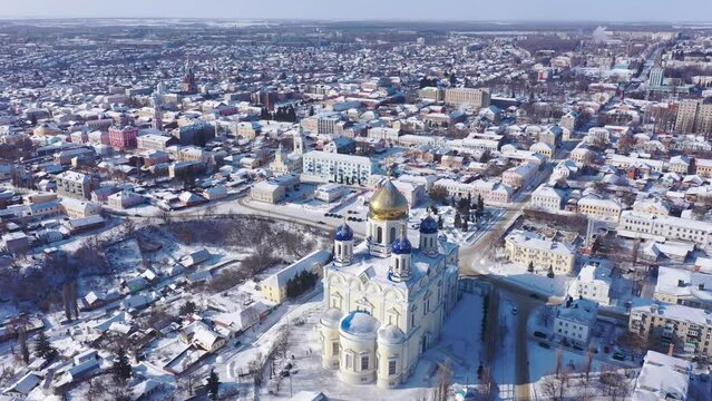 Aerial view of the Ascension Cathedral, located in the historical center of the city on the Red Square of Yelets, and the surrounding his residential areas in winter, Russia