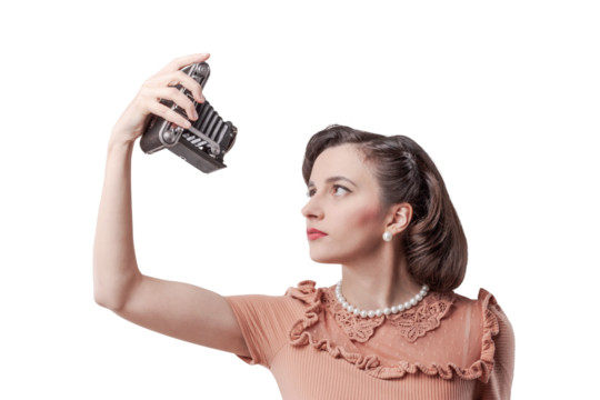 Beautiful woman taking selfies with vintage camera