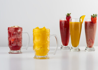 Fresh pressed juices of Mango, strawberry, and cocktail juice isolated on white background 