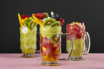 set of Fruit cocktails with fruit topping, Avocado, strawberry, Mango Cocktails with fruits and nut topping	
